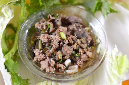 Thai dish of spicy minced pork eaten with vegetable