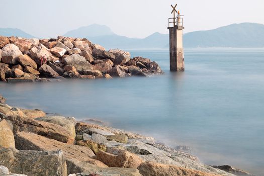 Lighthouse on a Rocky Breakwall: A small lighthouse warns of a rough shoreline. 
