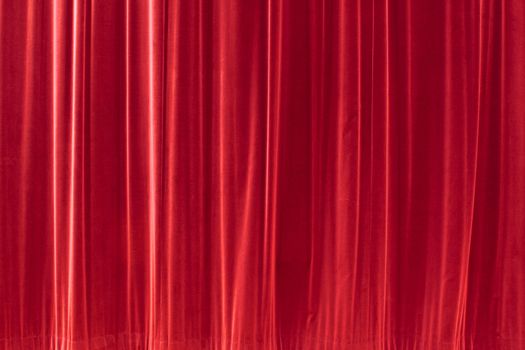 red background texture that looks like a silky fabric or curtain. This tiles seamlessly as a pattern. 