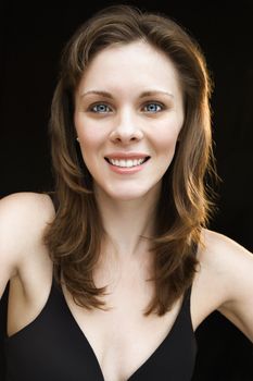 Head and shoulders portrait of young adult caucasian female smiling.