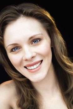 Close up portrait of young adult caucasian female smiling.