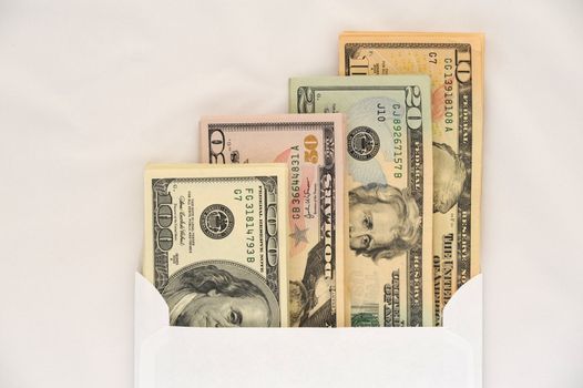 American Dollars in White Envelope on a White 
Background.