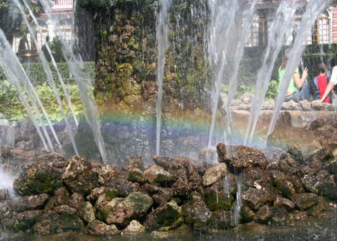 fountain in the park with rainbow
