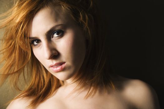 Studio portrait of pretty young redheaded female.
