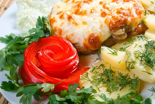 meat with potatoes and vegetable.Italian kitchen.Close-up