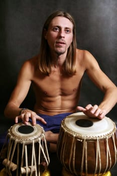 Man playing the nigerian drum in studio