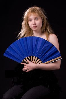 blonde girl on black with fan

