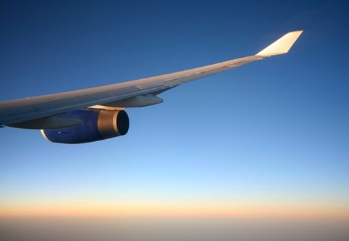 Wing of the plane on a background of sky