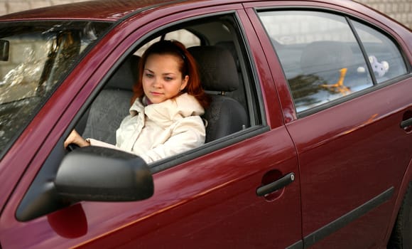 The young girl in the red automobile