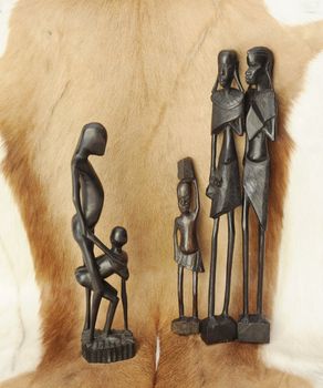 Lovely African Wooden Figures On Natural 
Animal Background.
