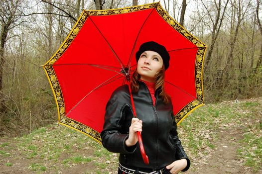 thoughtful girl with red umbrella