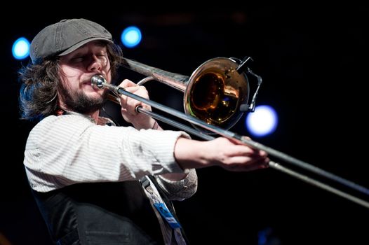 CANARY ISLANDS - NOVEMBER 12: Matthew Benson from Ireland playing trombone onstage with Brassroots during Womad 2011 November 12, 2011 in Las Palmas, Canary islands, Spain