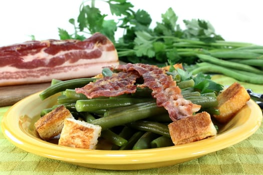 a plate of green beans and fried bacon