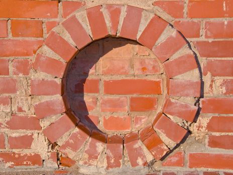 Red brick wall round circle details. Architectural backdrop.