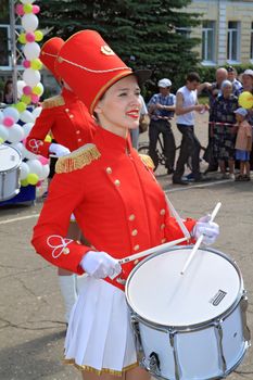 Staraya Russa, Russia - July 9: Young drummer girl at the parade on City Day Staraya Russa on July 9, 2011 in Staraja Russa, Russia.