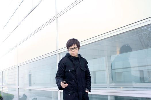 Business man using cellphone when waiting in station. 