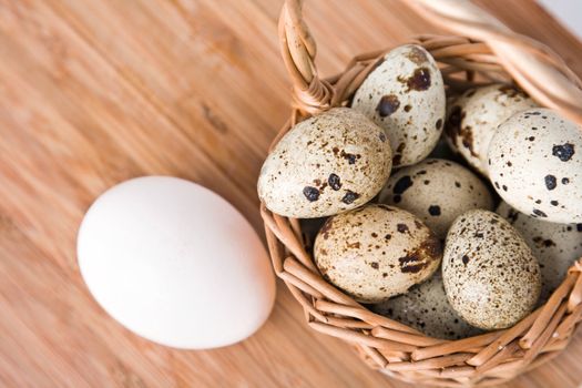 eggs in basket on a wood background, small focus