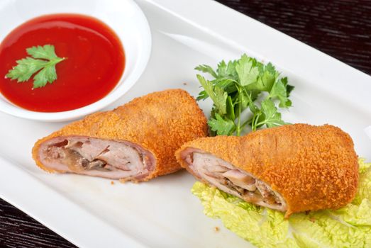 Closeup of rolls from pork meat, champignon mushroom, cheese and sauce