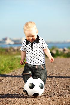  little boy play soccer outdoor