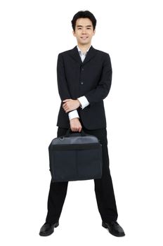 Full body of a smiling Asian businessman standing against isolated white background