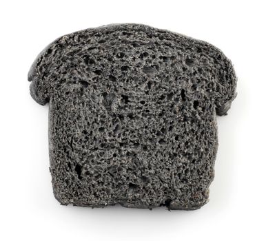 Single slice black charcoal bread on white background