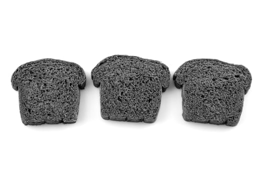 Three slices black charcoal bread on white background