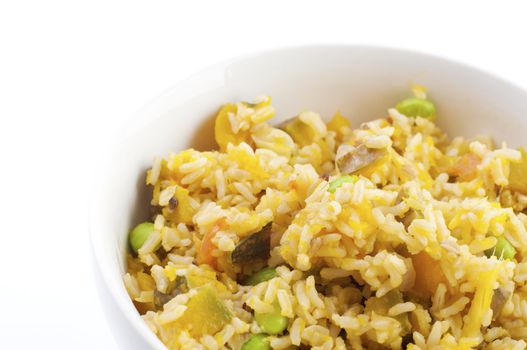 Bowl of pumpkin fried rice on white background