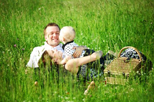  happy family on picnic in green grass