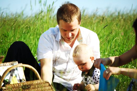  happy family on picnic in green grass