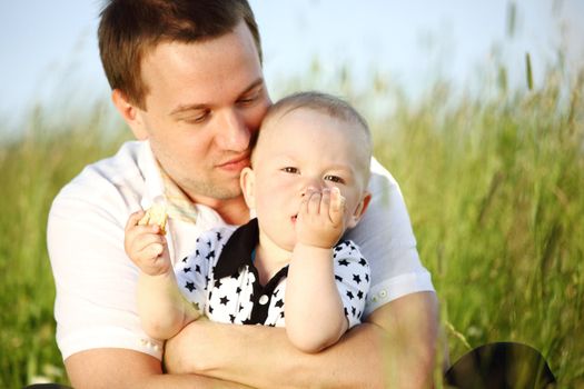 father and son in green grass