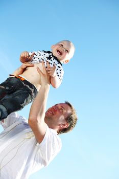 father and son in blue sky