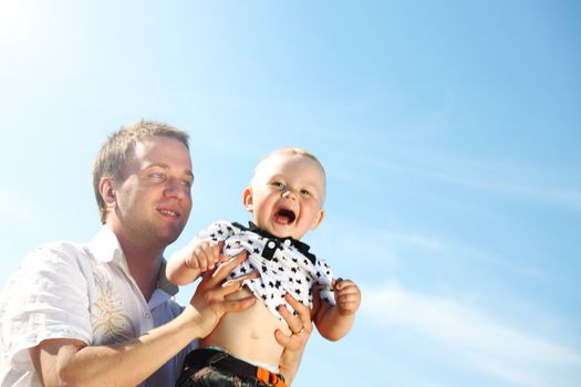 father and son in blue sky