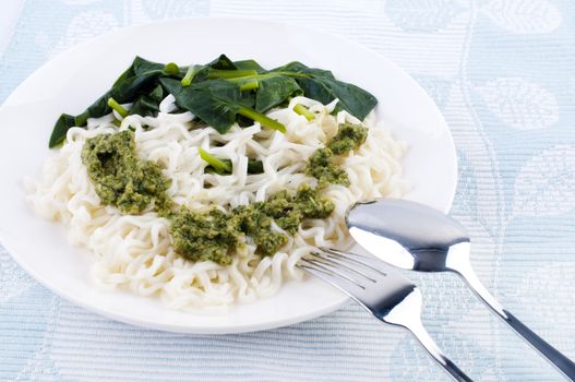 Japanese dry noodles with italian pesto souce and spinach vege, western mixed eastern cooked.
