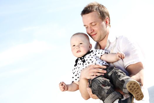 father and son in blue sky