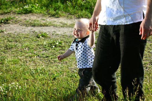 father and son walking on grass