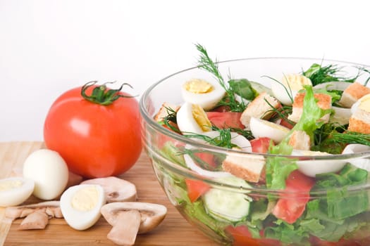 fresh raw vegetable salad in glass bowl