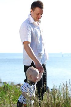 father and son walking on grass