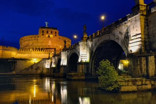 Bridge crossing the river Tiber and Castle Sant'Angelo illuminated at night