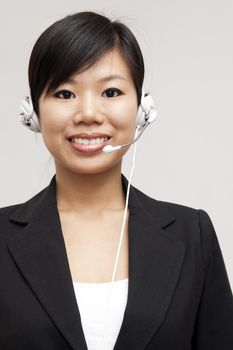 Friendly Customer Representative with headset smiling during a telephone conversation