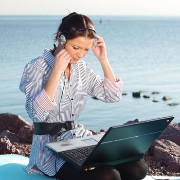 woman with laptop sea background