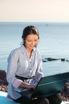 woman with laptop sea background