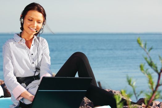 woman with laptop sea background