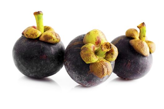 Three mangosteens fruit isolated on white background