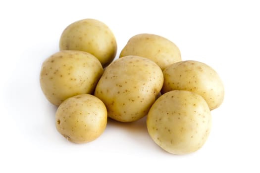 Seven potatoes isolated on a white background.