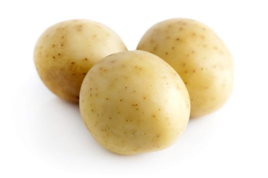 Three potatoes isolated on a white background. 