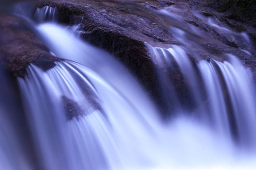 Zen garden waterfalls in dawn, slow shutter.