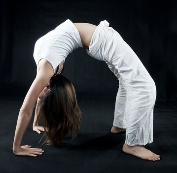 Female practising kung fu, on black background