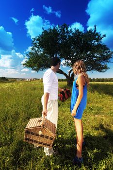 man and woman on picnic in green grass