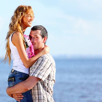 man and woman hug in the sky and sea on sea