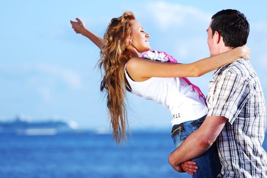 man and woman hug in the sky and sea on sea